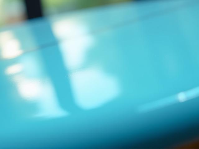 Close-up of a glossy surfboard finish reflecting light